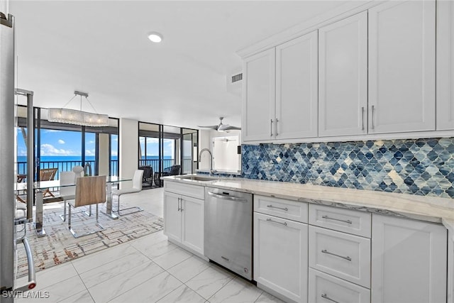 kitchen with a water view, dishwasher, sink, and white cabinets