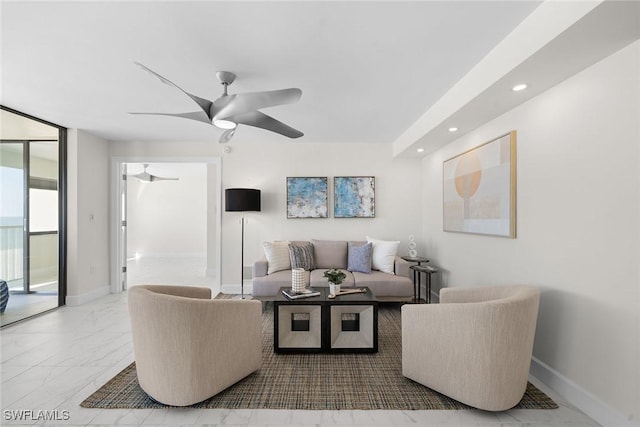 living room featuring expansive windows and ceiling fan