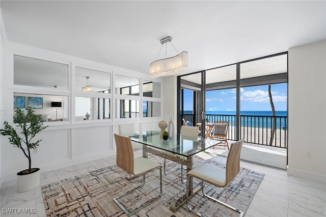 dining room with a water view and a beach view