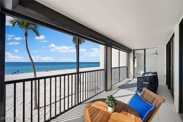 balcony with a water view and a beach view