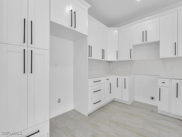 kitchen with white cabinets and decorative backsplash