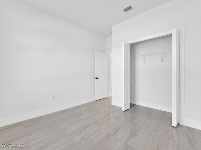 unfurnished bedroom with a closet