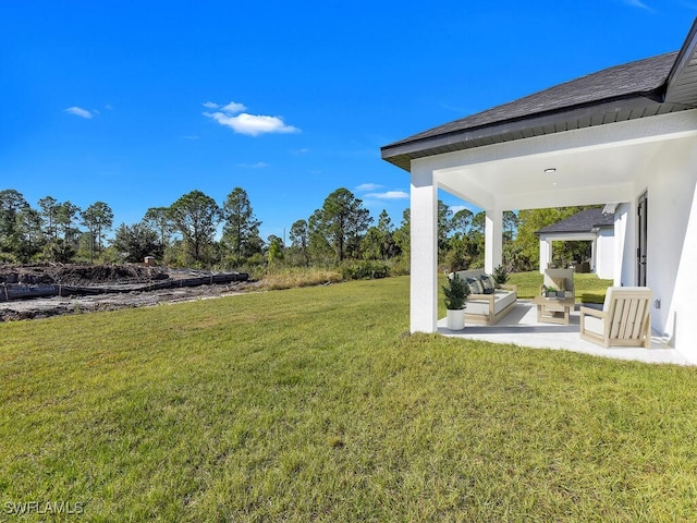 view of yard featuring an outdoor living space and a patio area