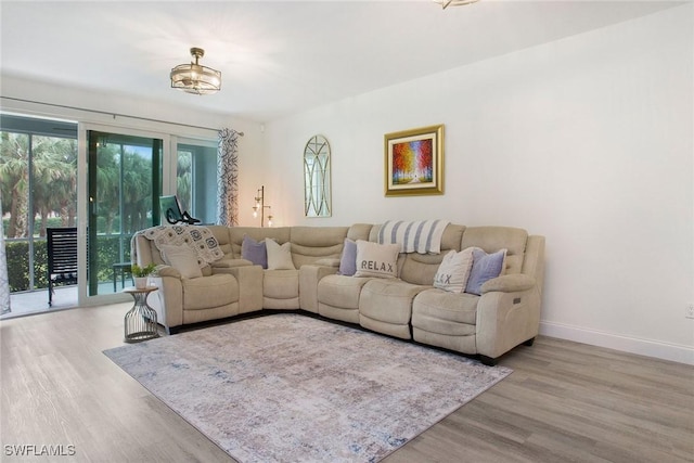 living area featuring light wood-type flooring and baseboards