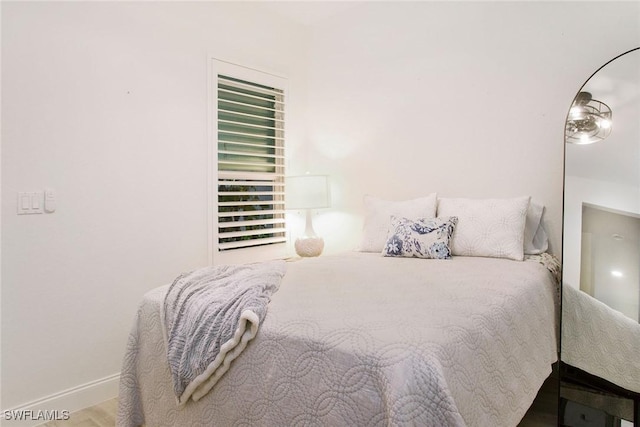 bedroom with wood-type flooring