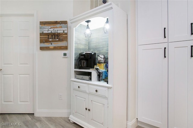 interior space featuring white cabinets and light hardwood / wood-style flooring