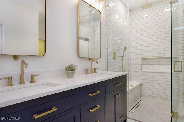 bathroom with vanity and a shower with door