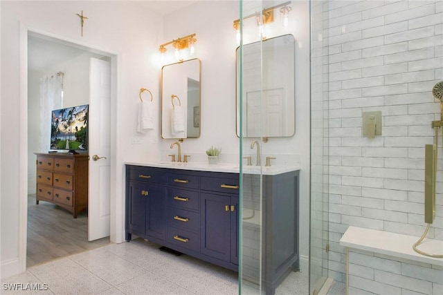 bathroom with vanity and a shower