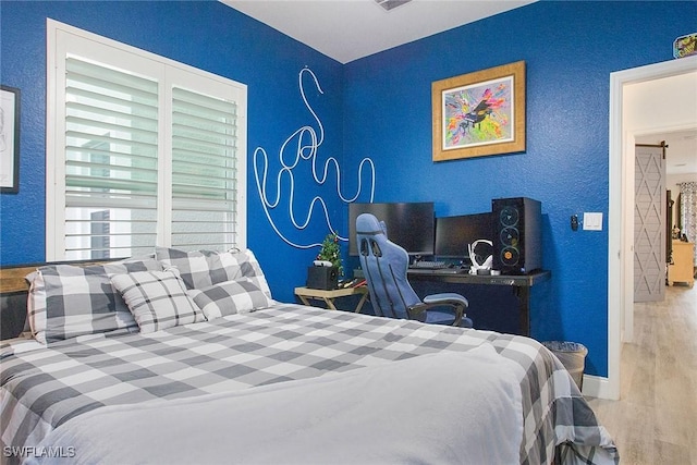 bedroom with wood-type flooring