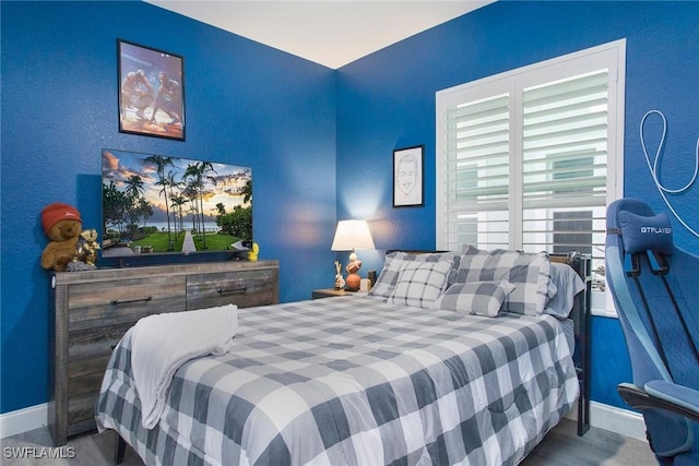 bedroom with wood-type flooring