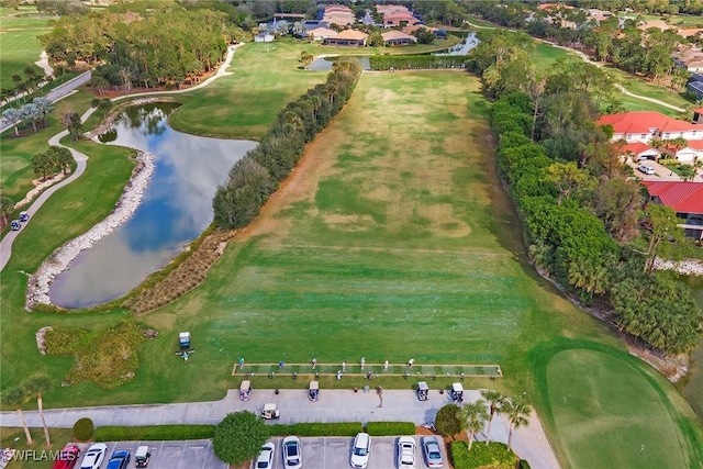 aerial view with a water view and view of golf course