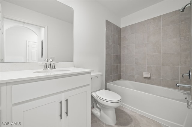 full bathroom featuring tiled shower / bath combo, vanity, tile patterned flooring, and toilet