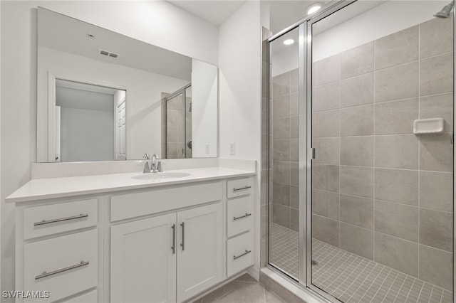 bathroom with vanity, tile patterned flooring, and a shower with shower door