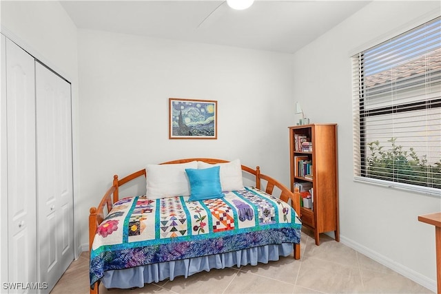 tiled bedroom featuring a closet