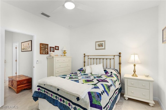 tiled bedroom featuring ceiling fan