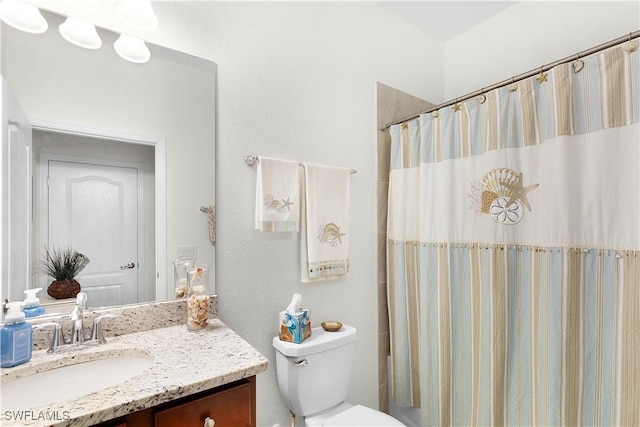 bathroom featuring vanity, toilet, and a shower with shower curtain