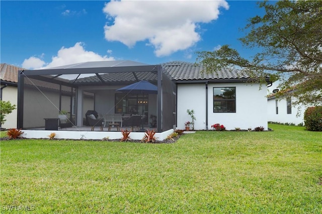 rear view of property with a lanai and a lawn