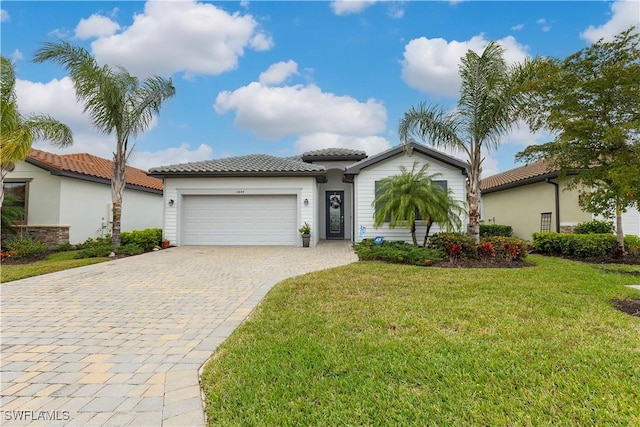 mediterranean / spanish-style house with a garage and a front yard