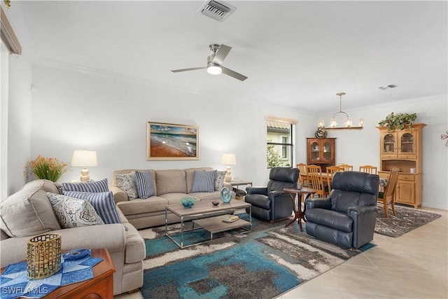 tiled living room with ornamental molding and ceiling fan with notable chandelier