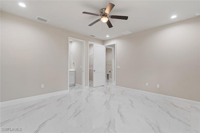 unfurnished bedroom featuring ceiling fan and connected bathroom