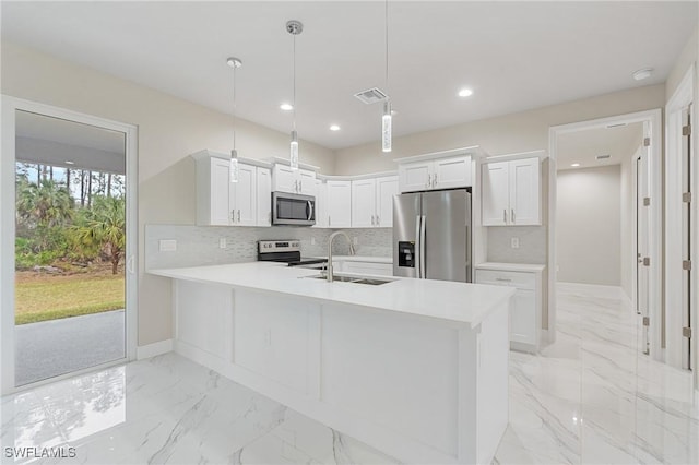 kitchen featuring appliances with stainless steel finishes, pendant lighting, sink, white cabinets, and kitchen peninsula