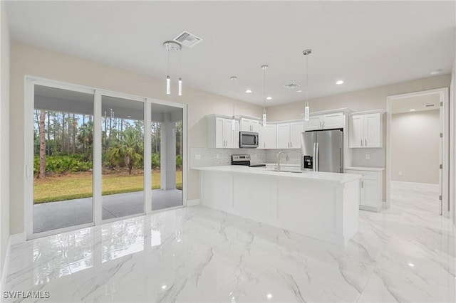 kitchen with pendant lighting, white cabinetry, sink, backsplash, and stainless steel appliances