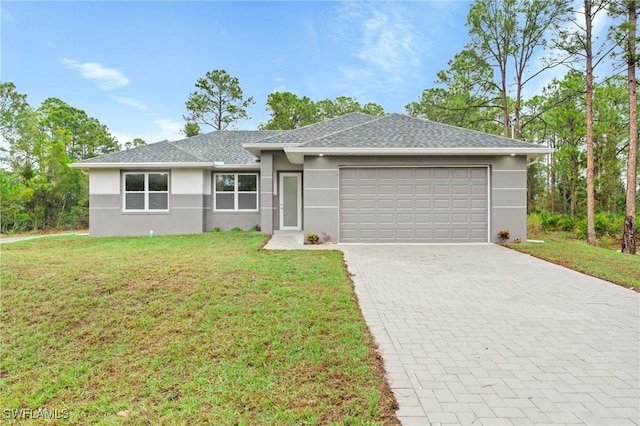 single story home with a garage and a front lawn