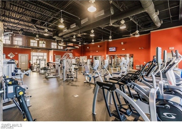 exercise room with a towering ceiling