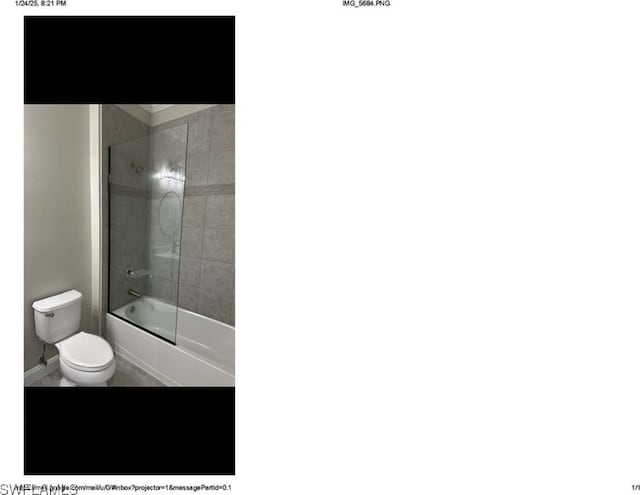 bathroom with toilet and bath / shower combo with glass door