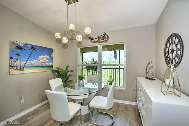 dining room featuring hardwood / wood-style flooring and vaulted ceiling