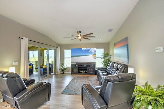 living room with lofted ceiling, light hardwood / wood-style flooring, and ceiling fan