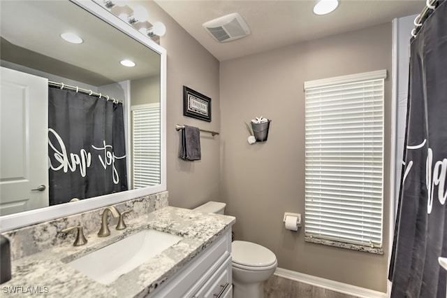 bathroom with vanity, hardwood / wood-style flooring, and toilet