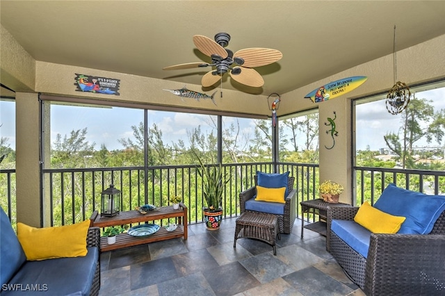 sunroom featuring ceiling fan