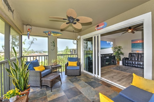 sunroom featuring ceiling fan