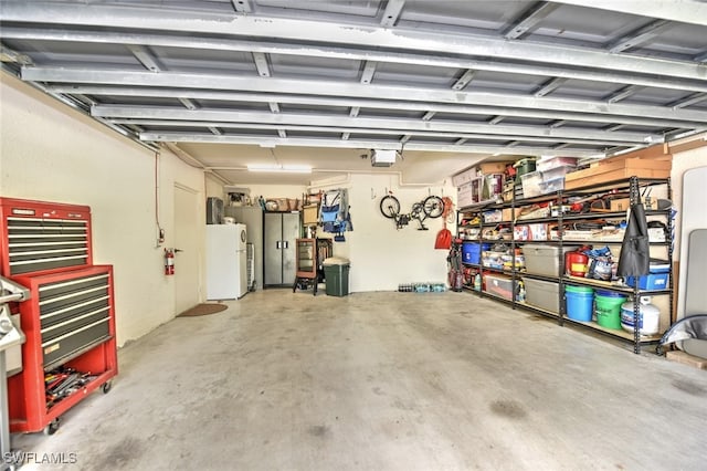 garage featuring white refrigerator and a garage door opener