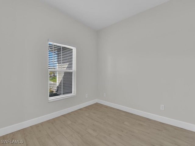 empty room with light hardwood / wood-style flooring