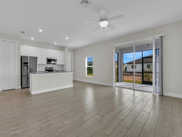 unfurnished living room featuring ceiling fan