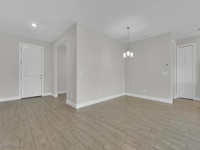 spare room featuring a chandelier