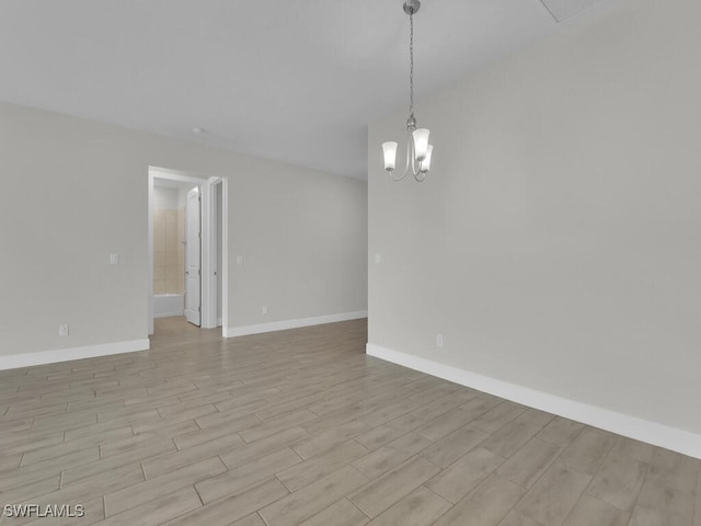 spare room featuring a notable chandelier