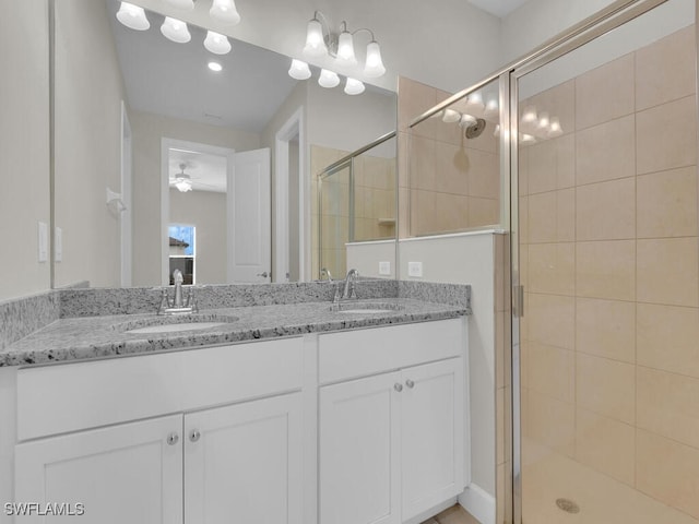 bathroom featuring vanity and a shower with door