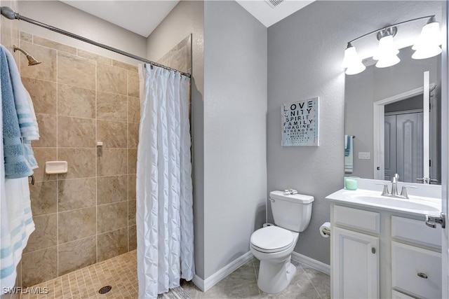 bathroom featuring vanity, tile patterned flooring, a shower with curtain, and toilet