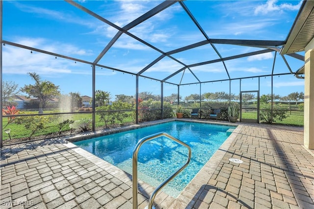 view of swimming pool with glass enclosure and a patio area