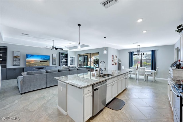 kitchen with white cabinetry, an island with sink, sink, hanging light fixtures, and stainless steel appliances