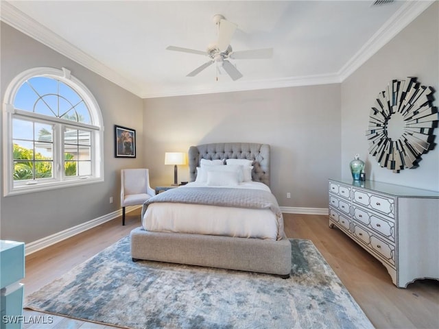 bedroom with crown molding, ceiling fan, and light hardwood / wood-style flooring