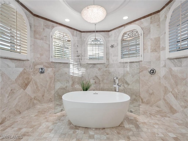 bathroom featuring tile walls and independent shower and bath