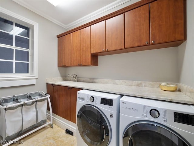 laundry room featuring separate washer and dryer, sink, crown molding, and cabinets