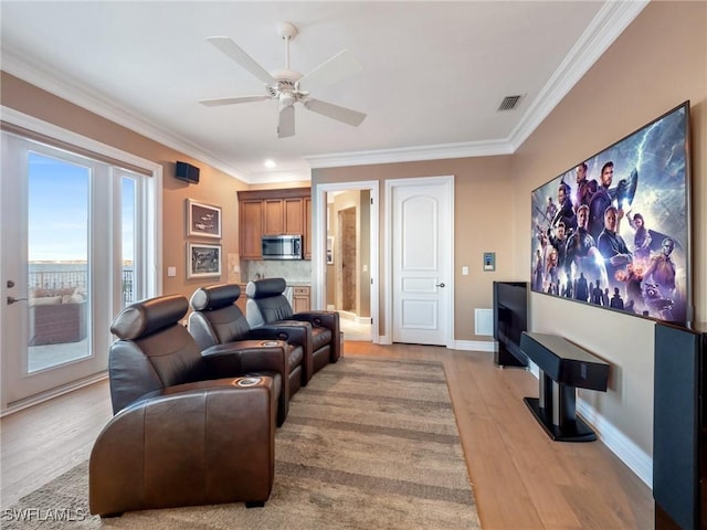 living room with crown molding, ceiling fan, and light wood-type flooring