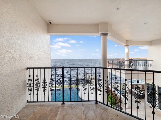 balcony featuring a water view