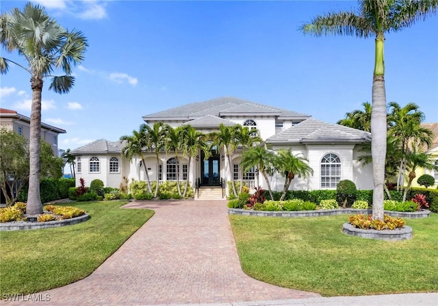 mediterranean / spanish-style home with a front yard