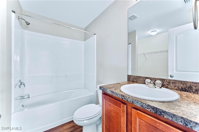 full bathroom featuring shower / bath combination, vanity, hardwood / wood-style floors, and toilet